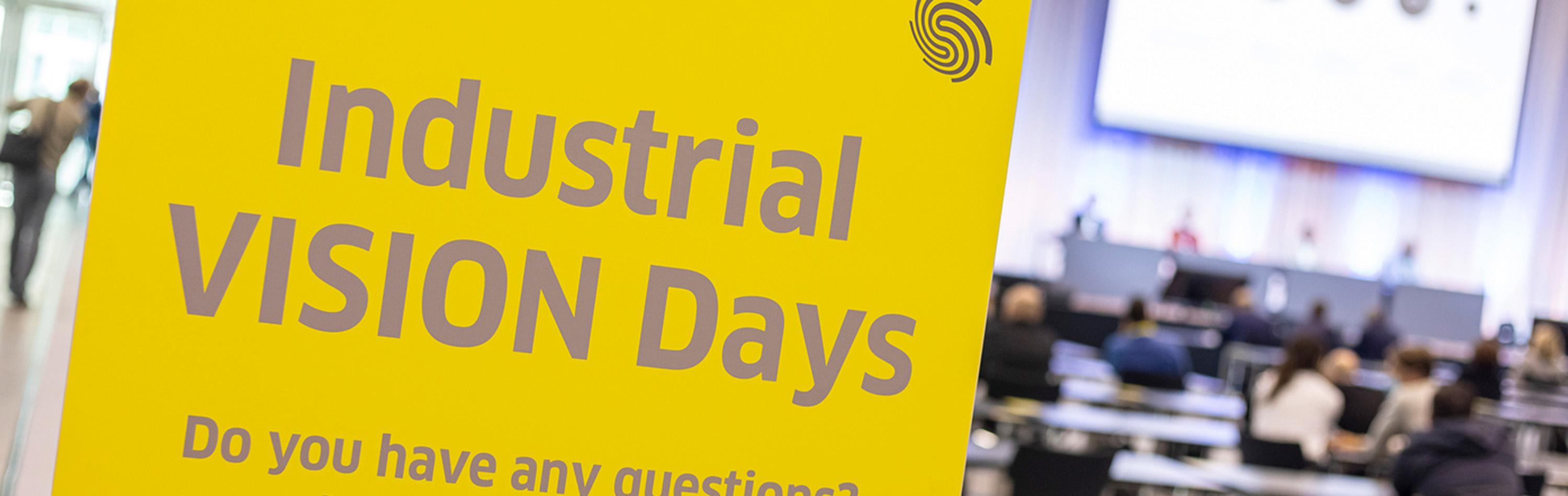 Industrial Vision Days font with lecture room blurred in the background.